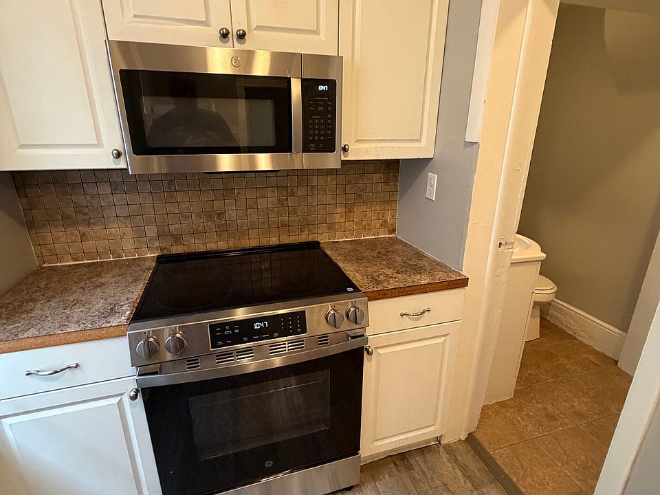New stove and microwave in kitchen.