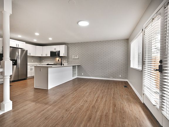 kitchen and dining area with new floors and paint.