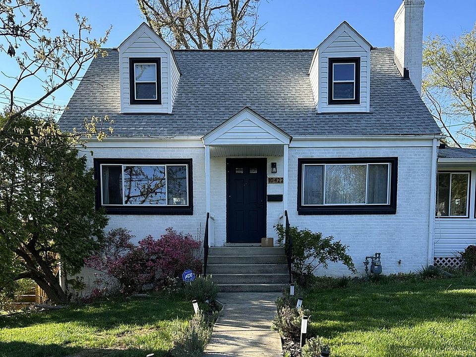 Single family home with 4 bedrooms, 3 full bathrooms, living room + four season sun porch, kitchen + kitchenette, outdoor deck, and shed