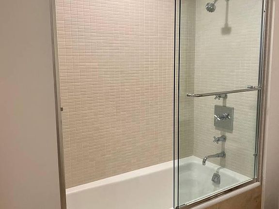 Tiled shower with sliding glass door