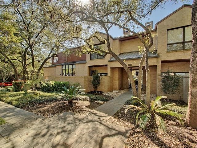 Lovely setting among large mature trees allows this town- house style end unit lots of privacy. with only one adjoining neighbor.  Greenbelt adjoins property to the left and entrance is just steps away!
