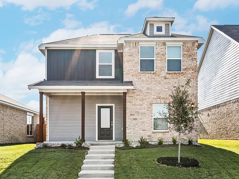 The Dogwood is a beautiful two-story home with a siding exterior and brick accents.