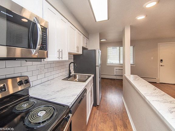 Renovated kitchen with granite countertops and white cabinetry