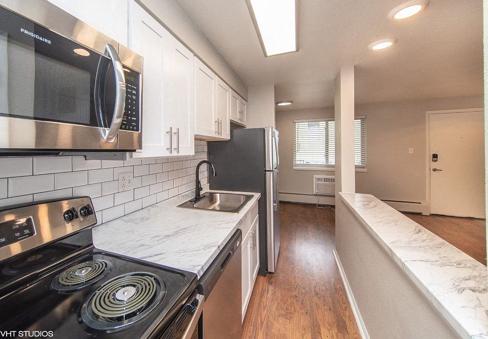 Renovated kitchen with granite countertops and white cabinetry
