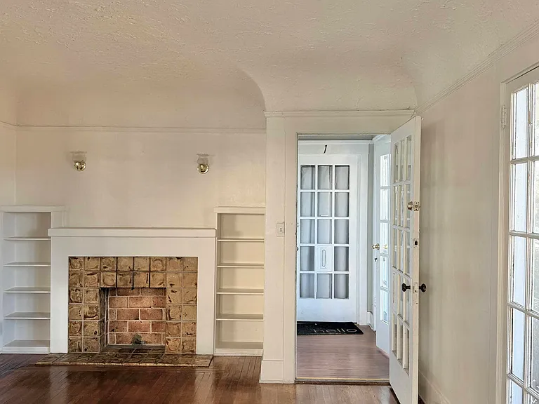 Living room with view to fireplace and entry door
