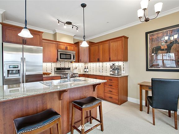 Granite countertops, stainless steel appliances, and hardwood cabinets.