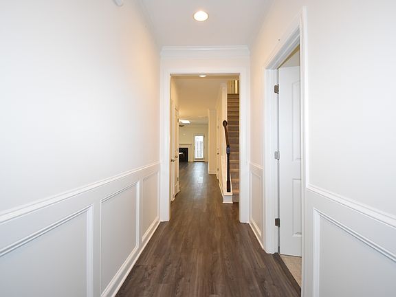 entry with the first floor guest bedroom or office on the right. The entrance from the garage is on the left.