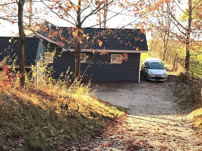 Steep driveway, parking area for two cars until the temps dip below freezing, then you walk a set of stairs.