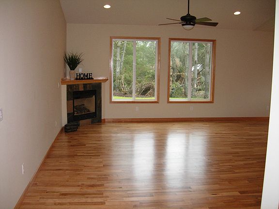 Great room has corner gas fireplace and 9 foot vaulted ceili