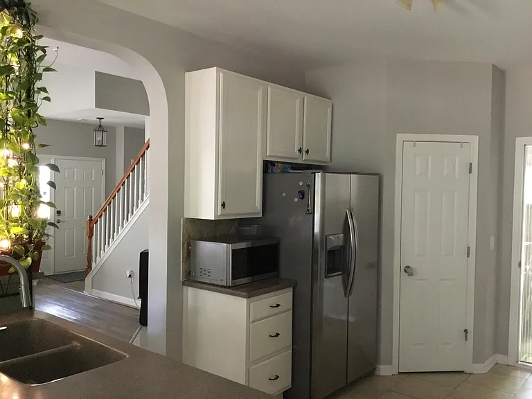 Kitchen with refrigerator, microwave