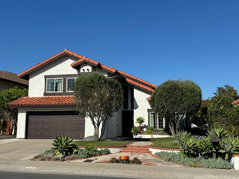 Beautifully maintained executive residence with timeless curb appeal, featuring mature landscaping, a tile roof, grand two-story entry, and an inviting front courtyard approach. Thoughtfully updated throughout.
