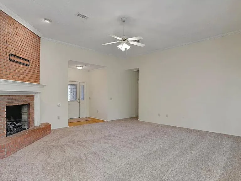 Family room. Very open. Lots of windows across the back. Hallway to bedrooms. Front door