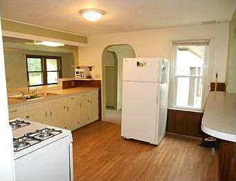 Coved doorway between entry way and kitchen shows the charm in this country home.