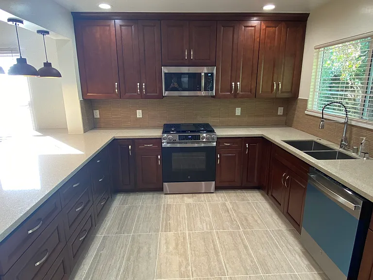 Kitchen view of range and microwave