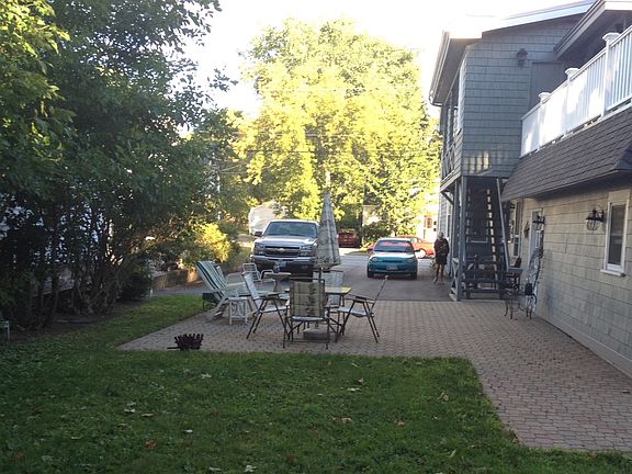 Two tandem parking spaces in driveway where the truck is parked next to the fence.