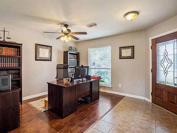 Light reflects through the beautiful front door as you lead into an entry and off to the study.
