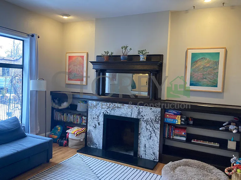 Living room with fireplace and built in shelving