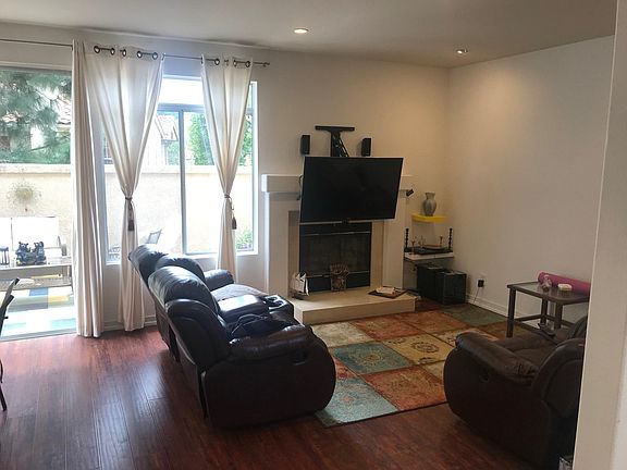 Living room with big windows/patio access and fireplace