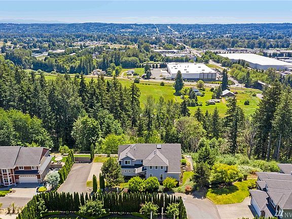 Surrounded by trees and natural hillside, this home offers beautiful valley views