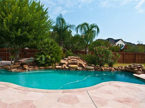 A waterfall crowns the sparking pool.