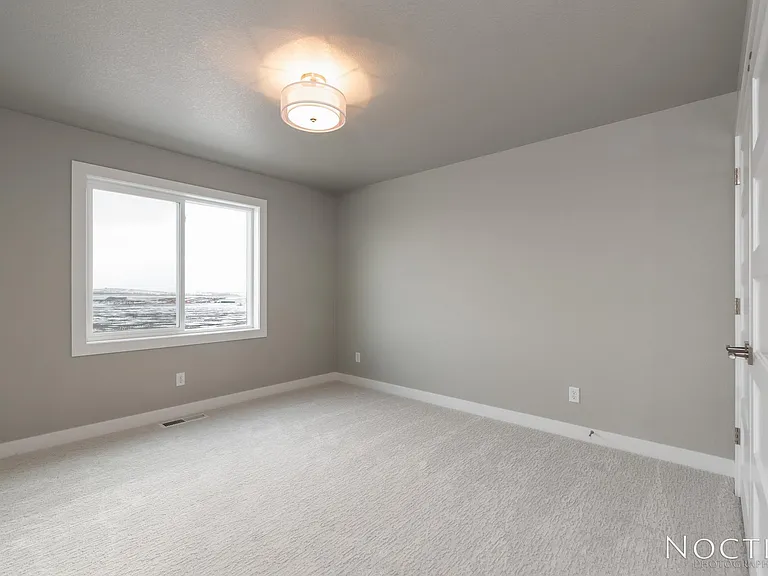 One of two extra bedrooms upstairs. (Photo of another unit with similar finishes and quality.)