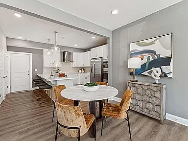 The open-concept kitchen and dining area provides seamless flow for daily living, with convenient access from the rear-load garage, making unloading groceries, household supplies, and daily routines effortless.