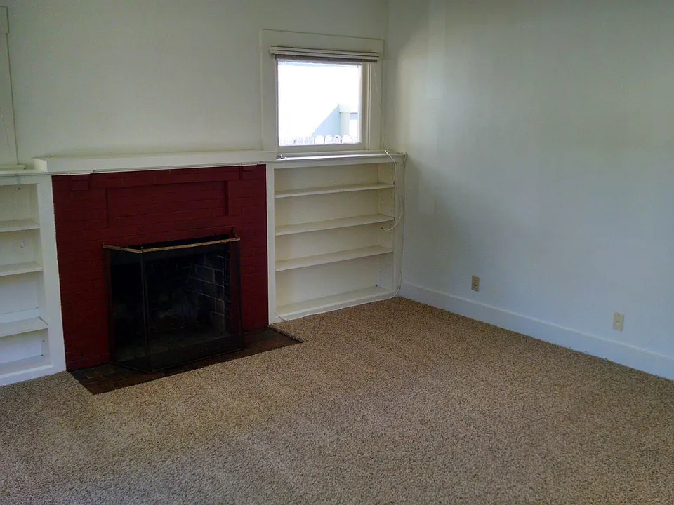 Fireplace, built-in bookshelves, new carpet