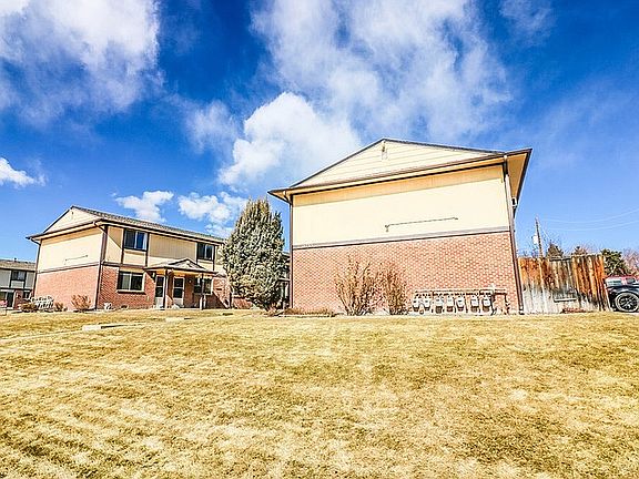 Explore this charming dual-unit residence, featuring bright exteriors and ample green space.