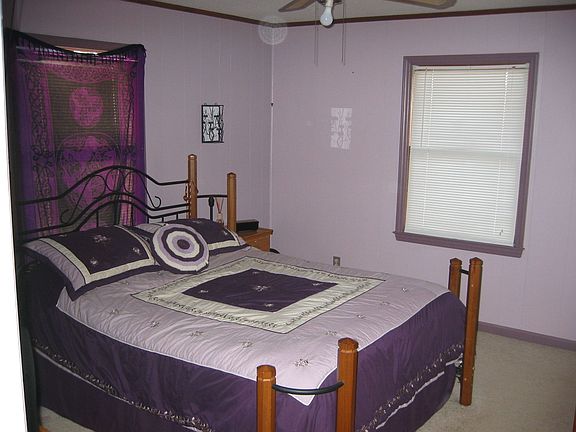 View Of Master Bedroom. 3/4 bath, carpeting, ceiling fan and crown molding.