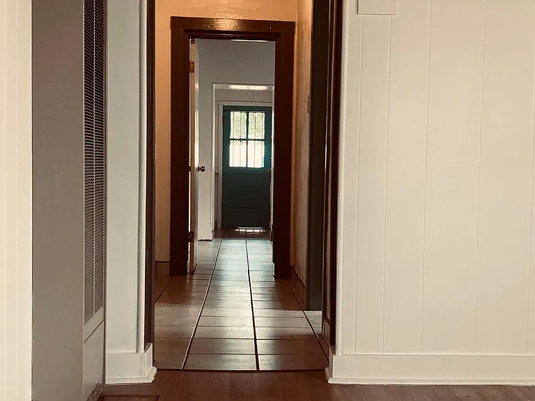 hallway view from the front door through the apartment. lots of natural light and original Vegas throughout the property.