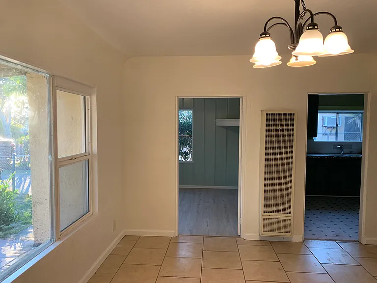 View of front bedroom from dining room and next to kitchen.