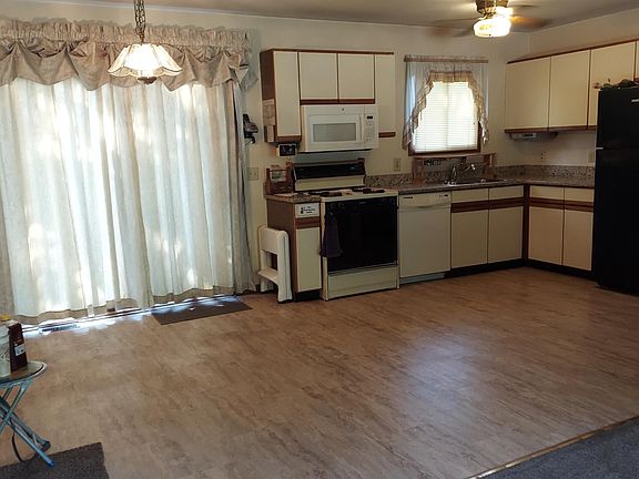 Dining room; Kitchen which includes: Electric can opener, over range microwave, oven/stove, dishwasher, refrigerator and radio/dvd player.