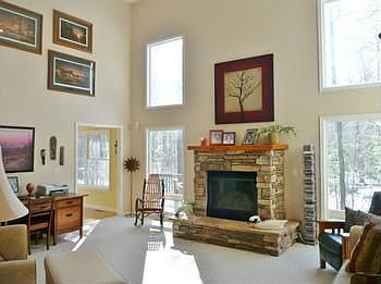 Cathedral ceiling are the feature of this spacious family room with a stone gas-log fireplace!