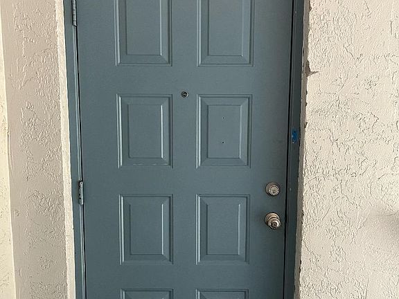 Front door with dead bolt and peephole