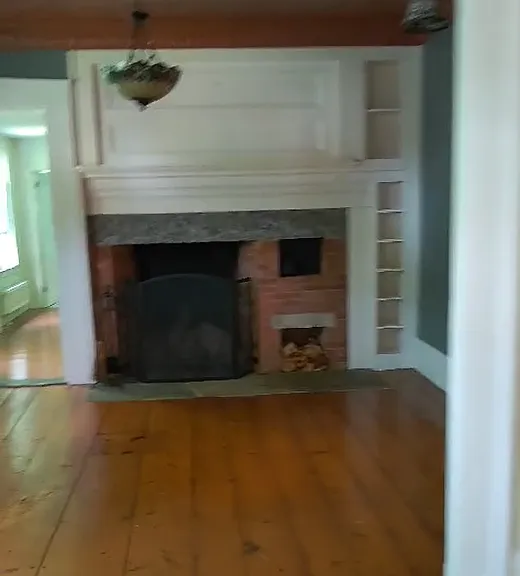 back living room with inoperable fireplace
