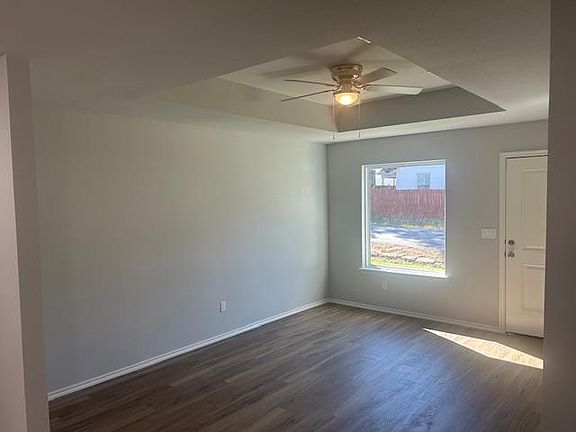 Living room, property now has faux wood blinds throughout