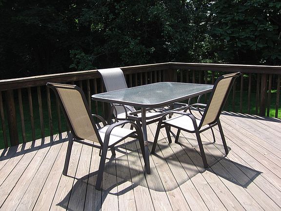 Deck overlooks Beautiful Yard