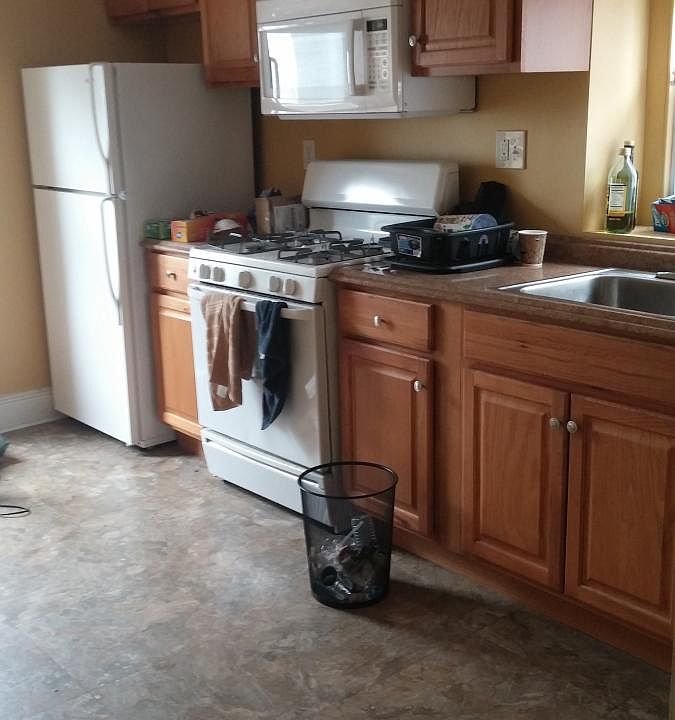 Kitchen with gas range and refrigerator