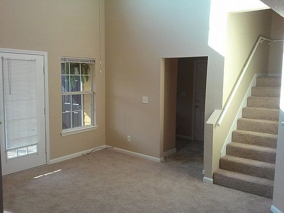 Living room, foyer doorway, stairs up to loft