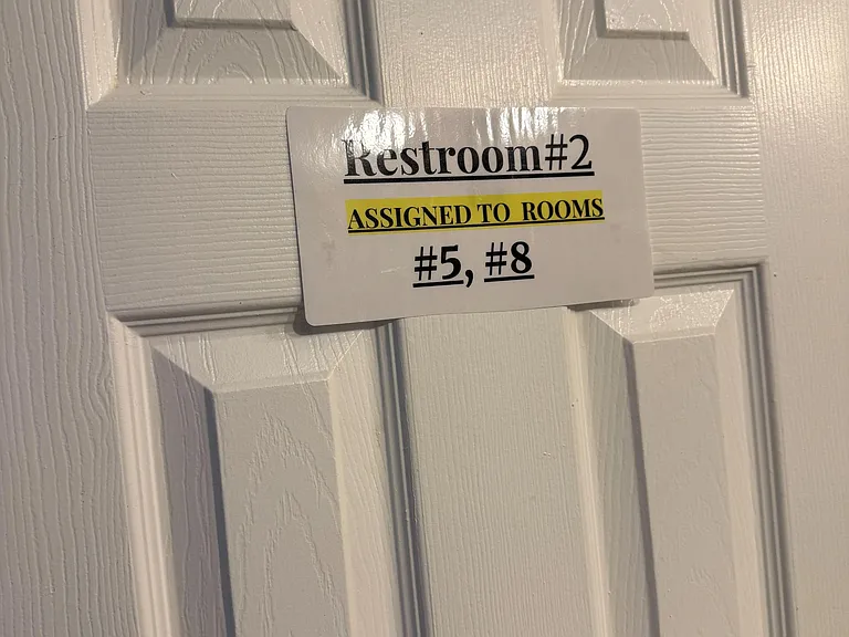 Shared bathroom with clearly designated access for residents, supporting organized use in a multi-room home.
