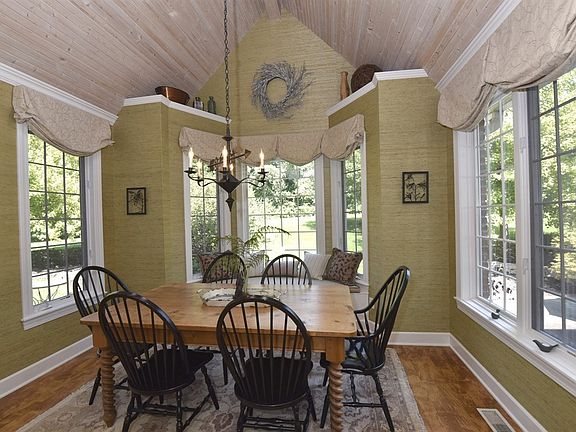 Casual dining area under cathedral ceiling with skylights