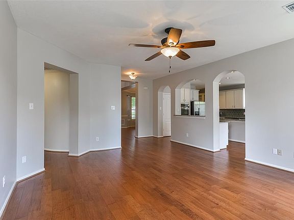 Another view of living room and beautiful arched door ways to the kitchen.