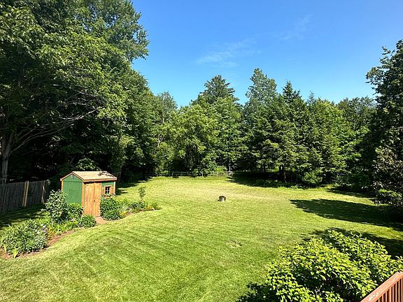 Fenced in backyard with deck and hot tub