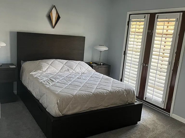 Master bedroom w/ private balcony through french doors