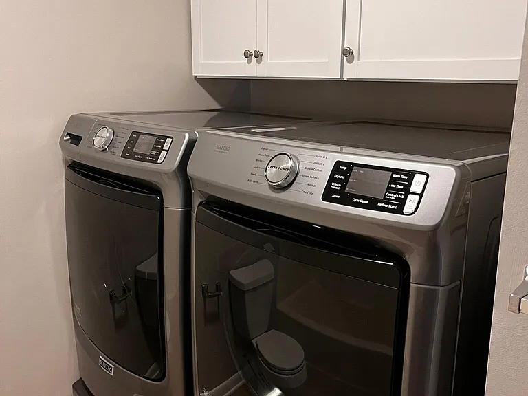 washer and dryer on pedestal for extra storage.