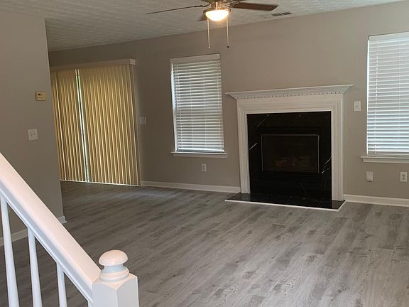 Living room with brand new wood-look luxury vinyl plank floors and new ceiling light/fan fixtures