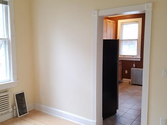 Dining room with ceiling fan and two windows.