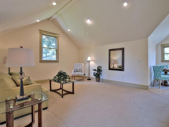 Living room section of the upstairs cottage with window overlooking the garage and the back yard. Kitchen and front door entry is toward the right side of the photo.