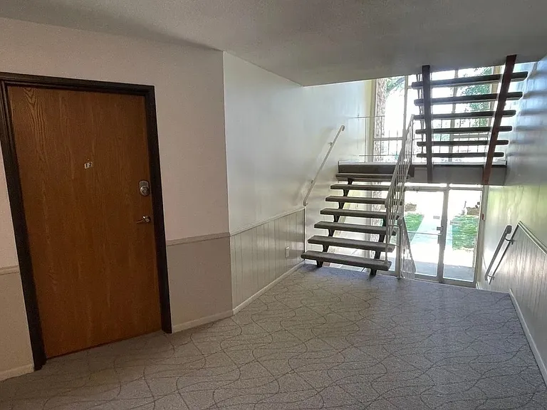 Step into the elegance of LS Capital Group, where modern design meets comfort. Enjoy this inviting entryway and its sleek staircase, perfect for welcoming you home. Don't miss out on your ideal living space; explore your options today!