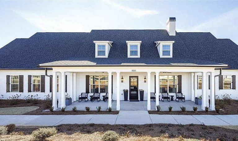 Clubhouse exterior with ample parking for future residents and visitors.